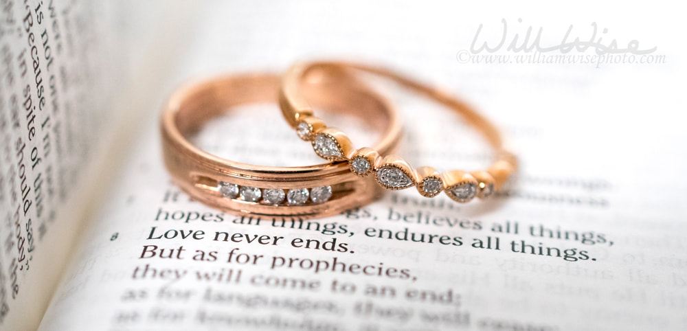 Gold Wedding rings on Bible verse, Love Never Ends Picture