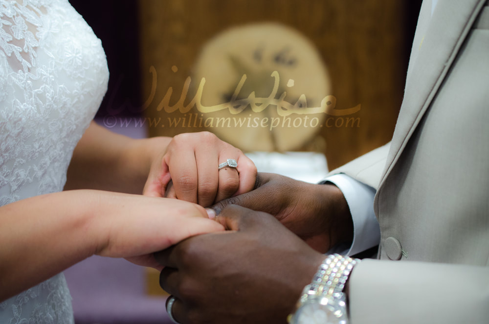 Interracial couple holding hands a the wedding altar Picture